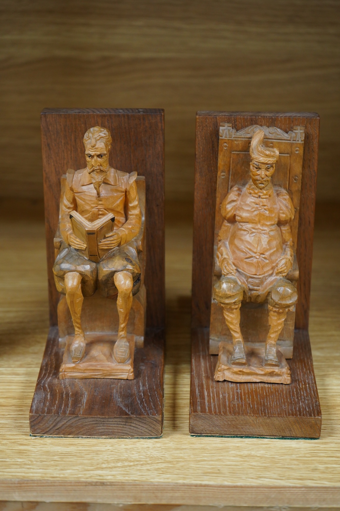 A pair of Bavarian carved wood figural bookends, 17cm high